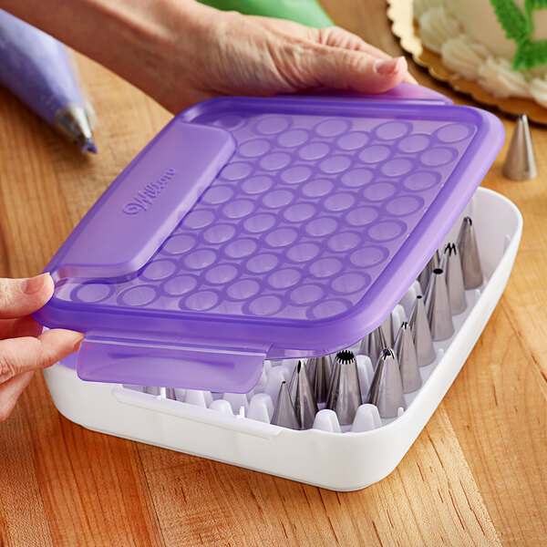 A purple plastic container with nozzles inside.