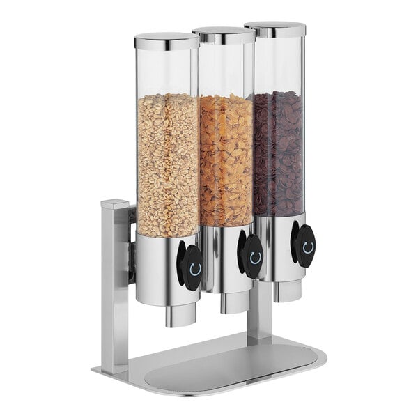 A WMF stainless steel triple cereal dispenser filled with three types of cereal.