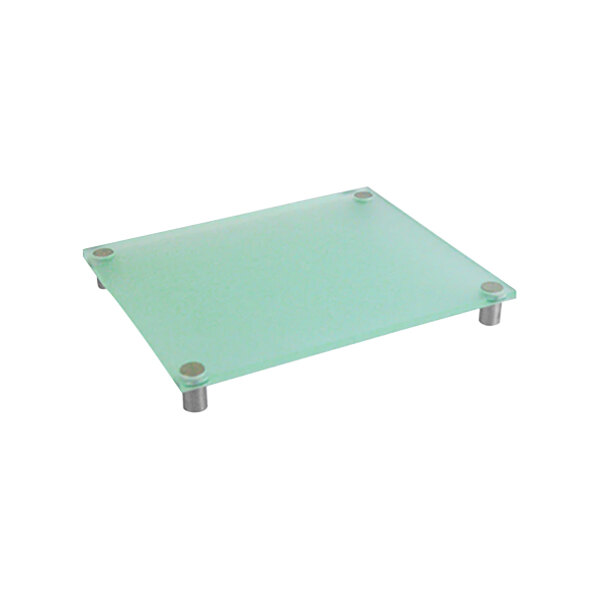 A Dalebrook clear green acrylic riser on a table with metal legs.