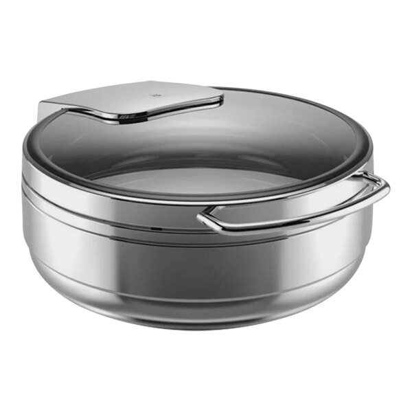 A WMF stainless steel round chafing dish with a lid.