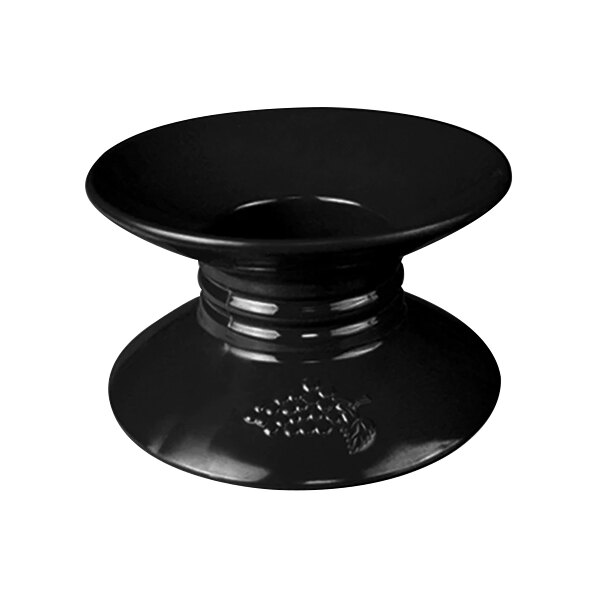 A black pedestal stand with an embossed grape design on top.