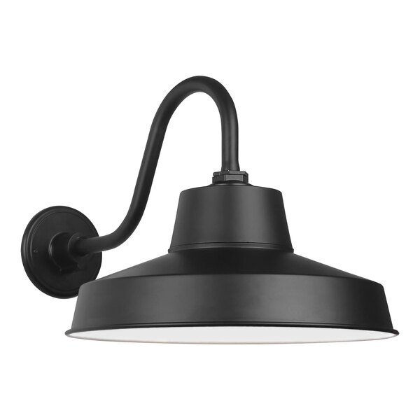 A black Canarm outdoor LED barn light with a curved arm and white shade.