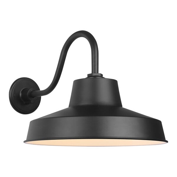 A matte black Canarm outdoor barn light with a curved arm and white shade.