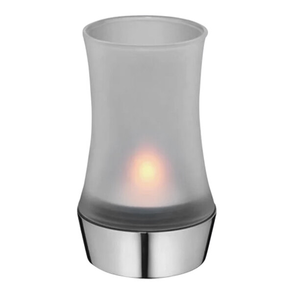 A WMF stainless steel tealight holder with a frosted glass shade and a lit candle inside.
