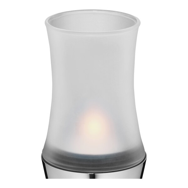 A WMF Urban glass candle holder with a white candle inside.