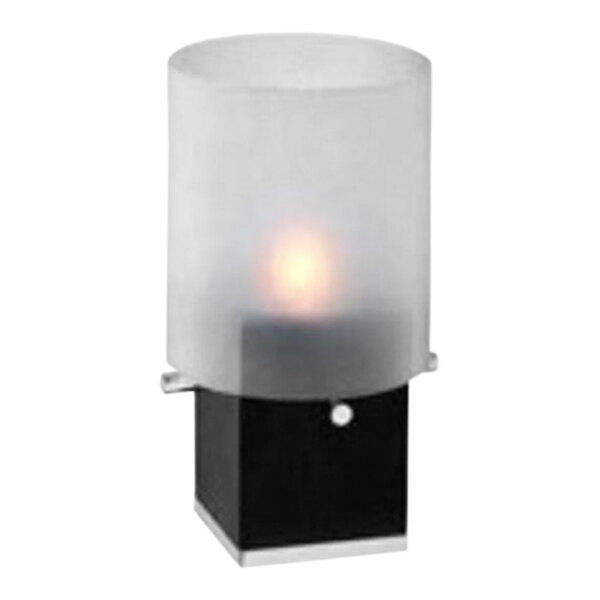 A dark wood tealight holder with a frosted glass shade over a lit candle.