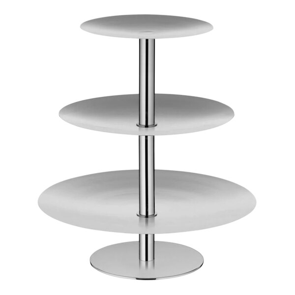 A WMF stainless steel three tier display stand with white round shelves and silver legs.