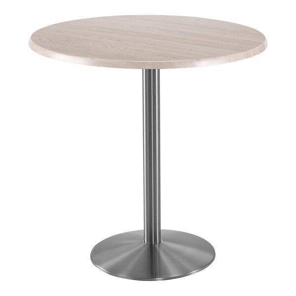 A Holland Bar Stool white ash round table with stainless steel base.