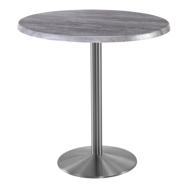 A Holland Bar Stool EnduroTop round table with a metal base and a greystone top.