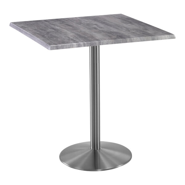 A Holland Bar Stool EnduroTop square table with a stainless steel base and greystone top.