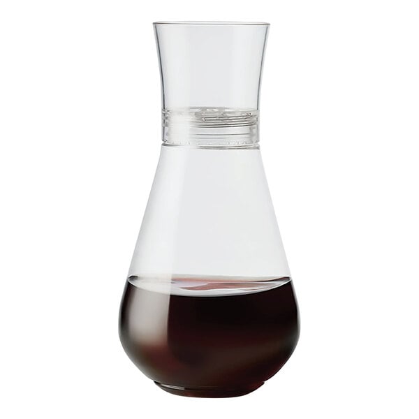A Tossware clear plastic decanter filled with a dark liquid.