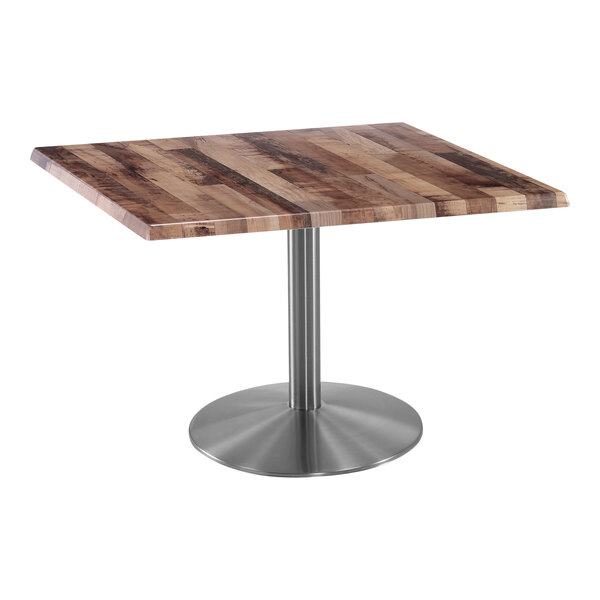 A Holland Bar Stool square table with a stainless steel base and wooden top.