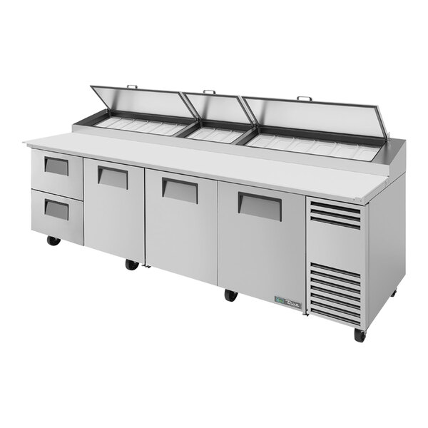 A True refrigerated pizza prep table with two drawers and three doors.