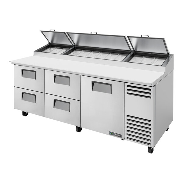 A True refrigerated pizza prep table with four drawers and one door.