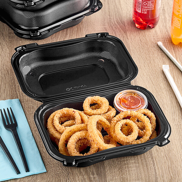 A black Genpak plastic hinged container with fried onion rings inside.