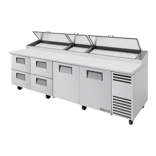A True refrigerated pizza prep table with four drawers and two doors.