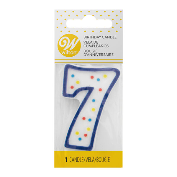 A blue Wilton birthday candle with white polka dots on the number 7.