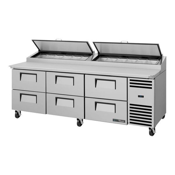 A True refrigerated pizza prep table with six drawers.