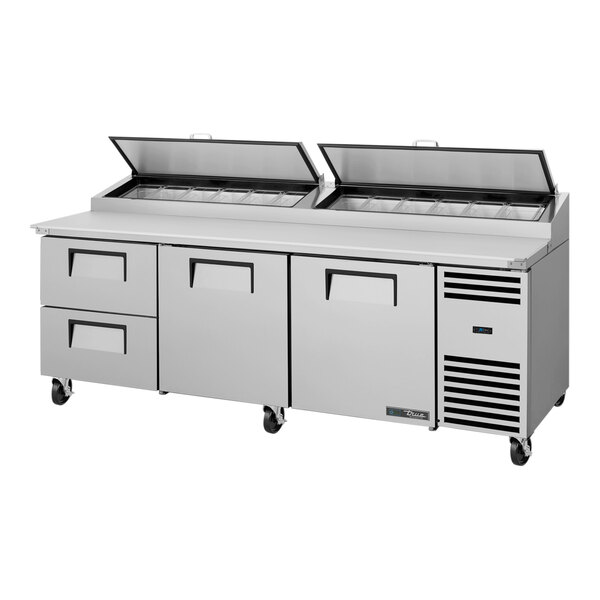 A True commercial refrigerated pizza prep table with two drawers and two doors.