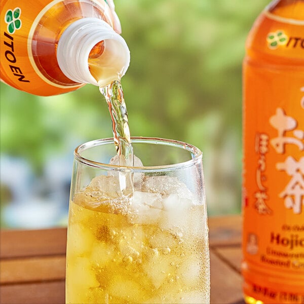 A bottle of Ito En Oi Ocha Hojicha Roasted Green Iced Tea being poured into a glass.