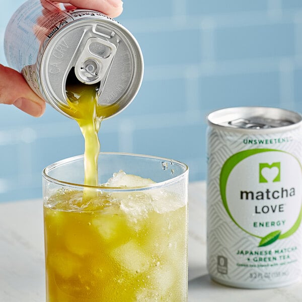 A hand pouring Ito En Matcha Love from a can into a glass of ice.
