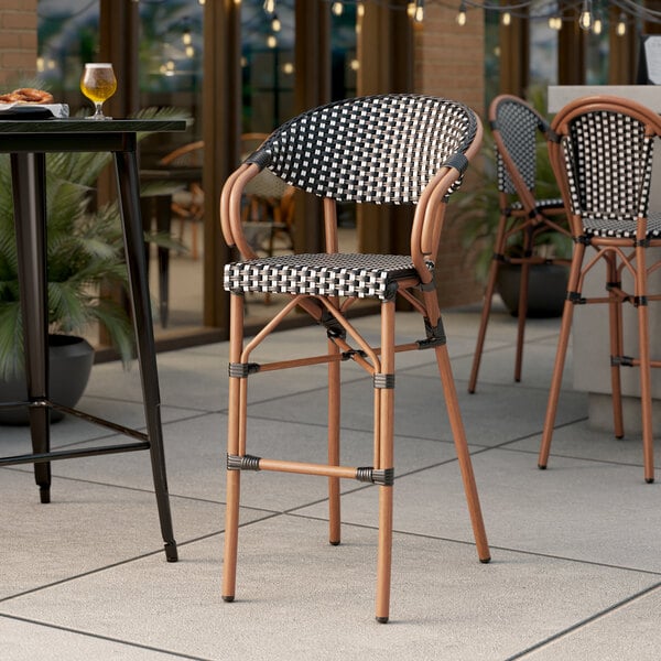Lancaster Table & Seating Bistro Series Black and White Checkered Weave Rattan Outdoor Arm Barstool