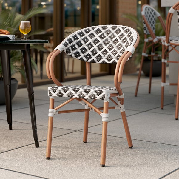 Lancaster Table & Seating Bistro Series Black and White Birdseye Weave Rattan Outdoor Arm Chair
