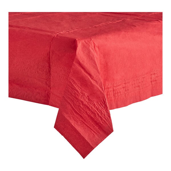 A red Table Mate tablecloth on a table with a folded napkin.