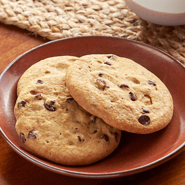 Two Otis Spunkmeyer chocolate chip cookies on a plate.
