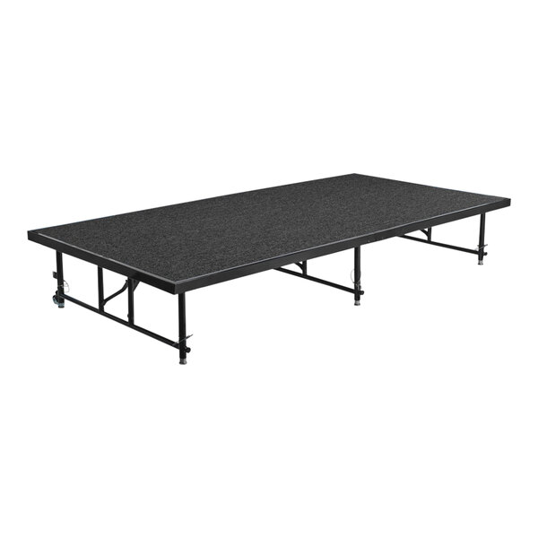 A black National Public Seating stage platform with metal legs.