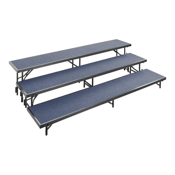 A National Public Seating blue carpeted choral riser with three levels.