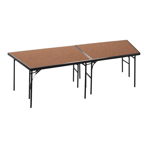 A National Public Seating hardboard stage pie on a table with two legs.