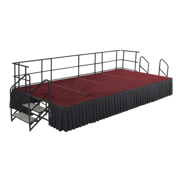 A red carpet stage with black skirting and guardrails.