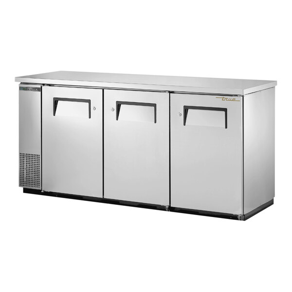 A stainless steel True back bar refrigerator with three solid doors.
