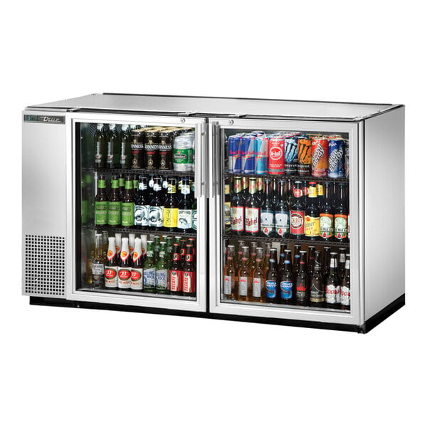 A stainless steel True back bar refrigerator with a glass door filled with beer and cans.