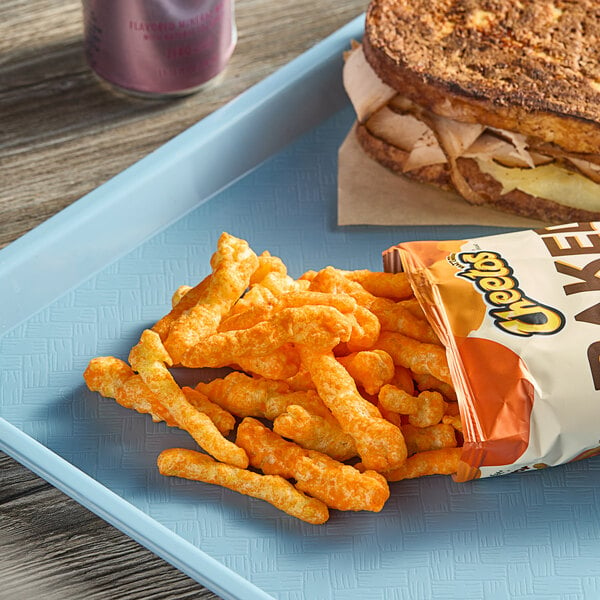 A bag of Cheetos Oven Baked on a blue tray with a sandwich.