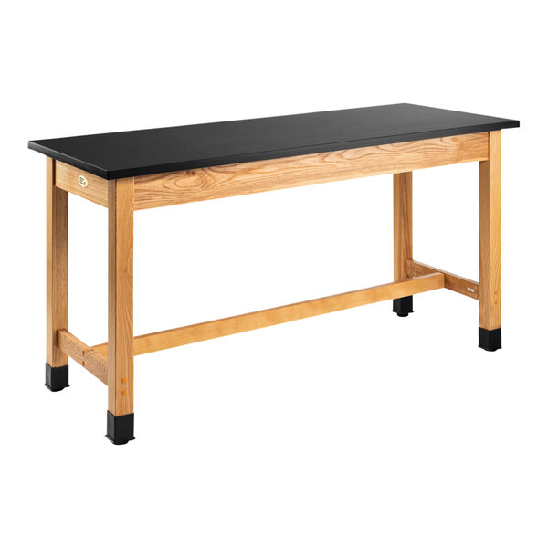 A black National Public Seating lab table with wooden legs.