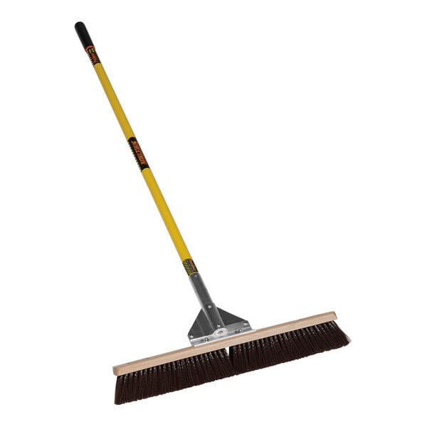 A Structron General Purpose Push Broom with a yellow handle.
