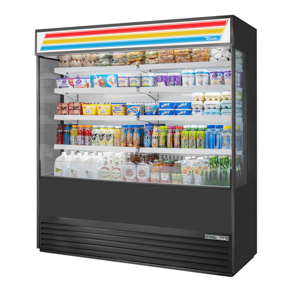 A True refrigerated air curtain merchandiser with a variety of products inside.