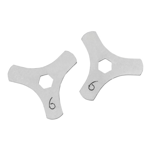 Two white metal hexagon CAM fittings with numbers on them.