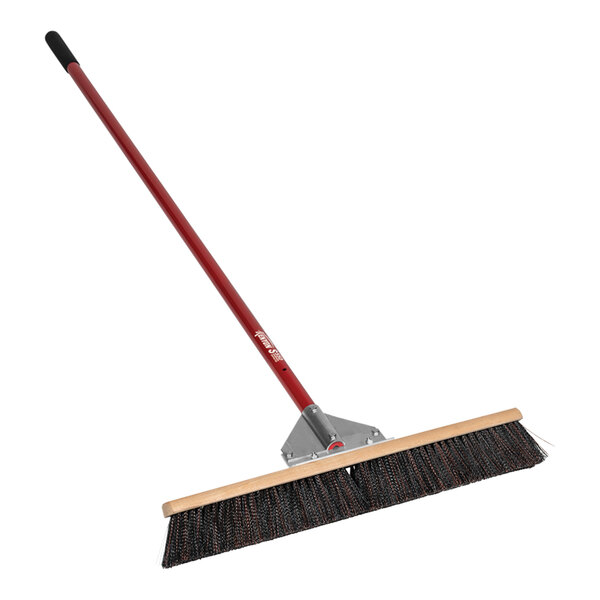 A Kenyon Wonder Push Broom with a red and black handle.
