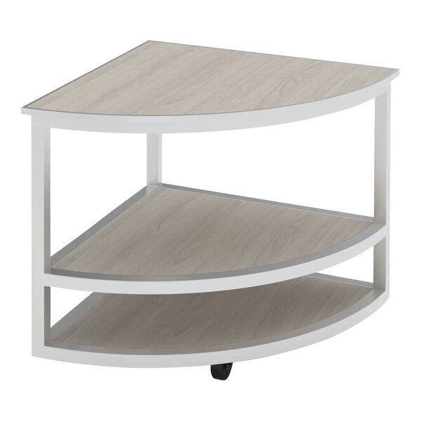 A Bon Chef rounded corner table with a white oak shelf and silver frame.