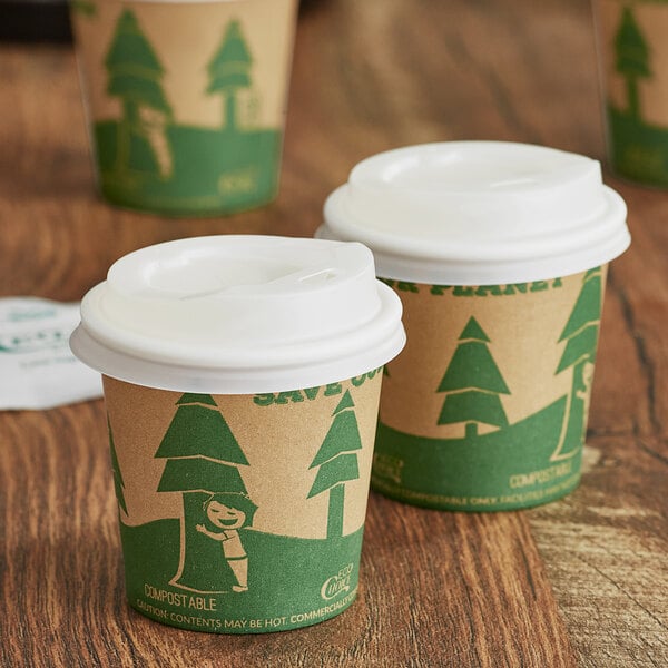 EcoChoice paper coffee cups with a kraft tree print and lids on a table.