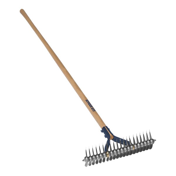 A Seymour Midwest thatching rake with a wooden handle and metal spikes.