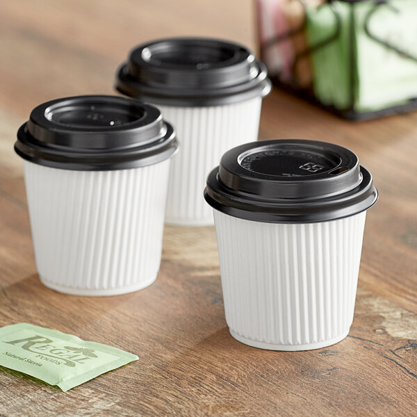 Three Choice white paper hot cups with black lids.