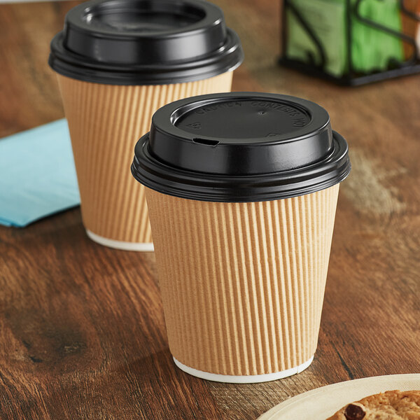 Two brown paper cups with black lids.