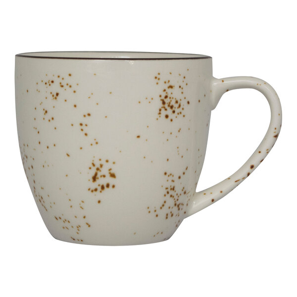 A white cappuccino cup with brown specks on it.