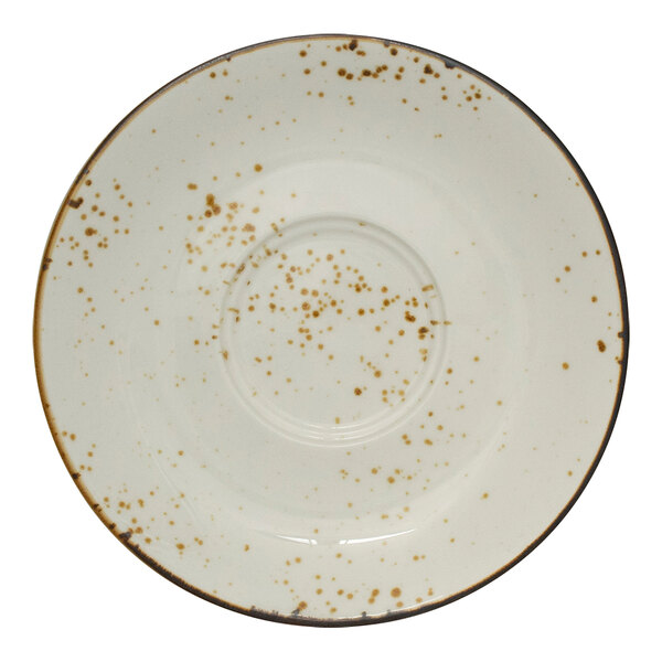A white stoneware saucer with brown specks.