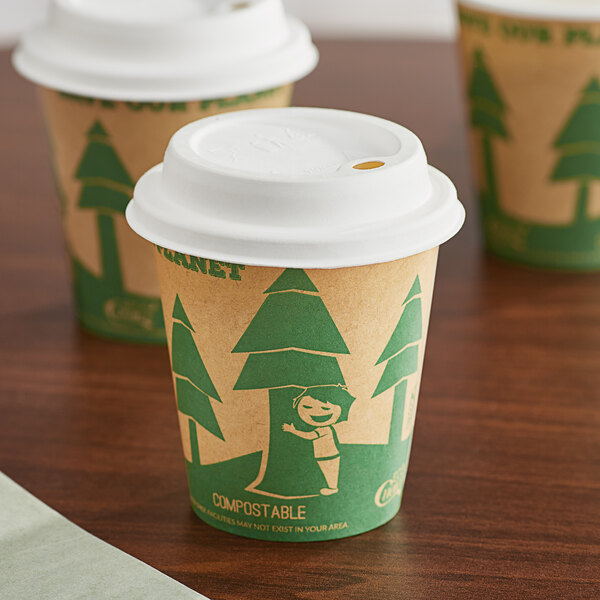 Two EcoChoice paper hot cups with green tree print on a table.