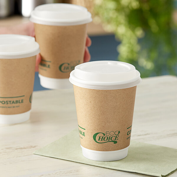 A brown EcoChoice paper hot cup with a white lid on a table.
